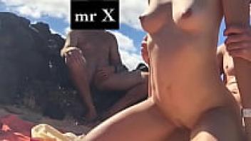 On the beach, Cuckold watches his wife receive love.