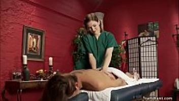A blonde masseuse rides the cock of a shemale.