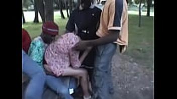In the park, an interracial gangbang