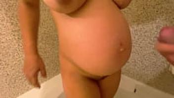 In the shower, the pregnant wife was adored.