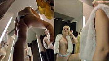 The fitting room has a hidden camera. Upskirt view of the large tits and pussy