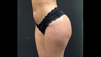 Before her massage, a spa client is filmed on a spinning platform wearing only her underwear and her entire body.