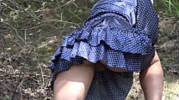 beneath a skirt without underwear. In nature, a large ass and hairy pussy in a short dress climb mountains.