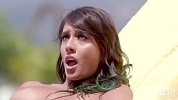 Watch Janice Griffith, a stunning hottie, finger her shaved pussy by the swimming pool.