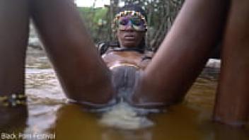 In the pool, a slender, dark-skinned African beauty teases