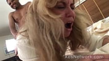 In an interracial video, a gorgeous blonde businesswoman rides a large black penis.